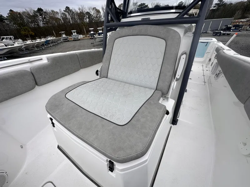 Slide: The Image of 2021 Sea Fox 288 Commander boat seat with gray upholstery, docked in a marina. - 14