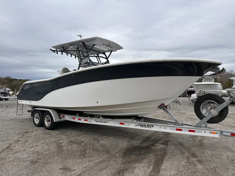 Slide: The Image of 2021 Sea Fox 288 Commander boat on trailer, parked outdoors under cloudy sky. - 2