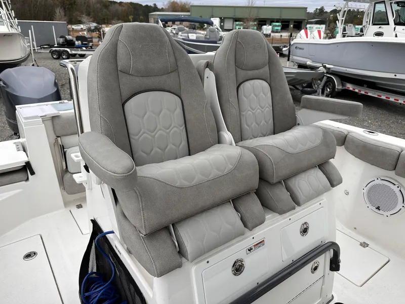 Slide: The Image of 2021 Sea Fox 288 Commander boat seats, gray upholstery, docked in a marina. - 22
