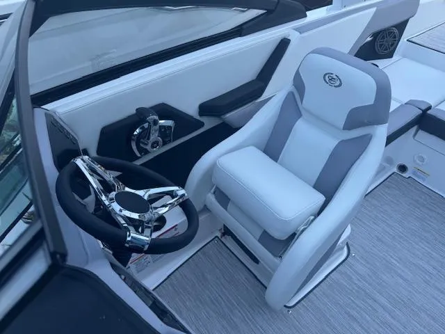 Slide: The Image of 2025 Cobalt CS22 boat interior with sleek steering wheel and comfortable captain's chair. - 16