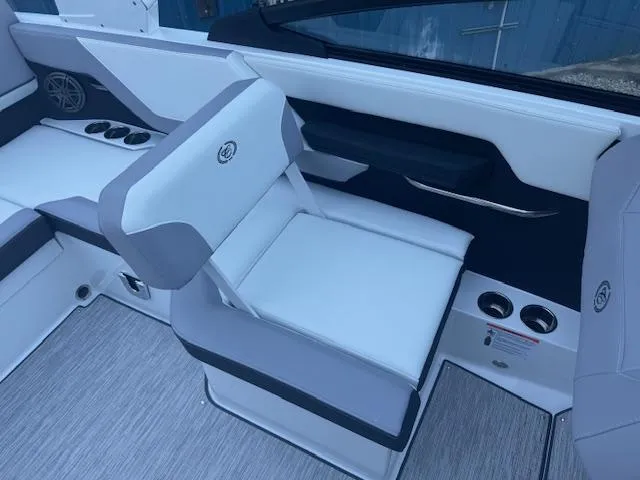 Slide: The Image of 2025 Cobalt CS22 boat interior with white and gray seating, cup holders, and sleek design. - 17