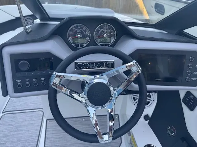 Slide: The Image of 2025 Cobalt CS22 boat dashboard with chrome steering wheel and modern controls. - 20