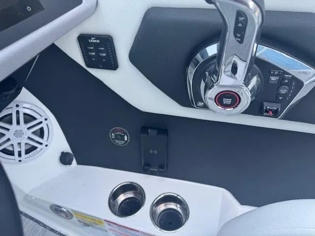 Slide: The Image of 2025 Cobalt CS22 boat dashboard with controls, cup holders, and speaker. - 22