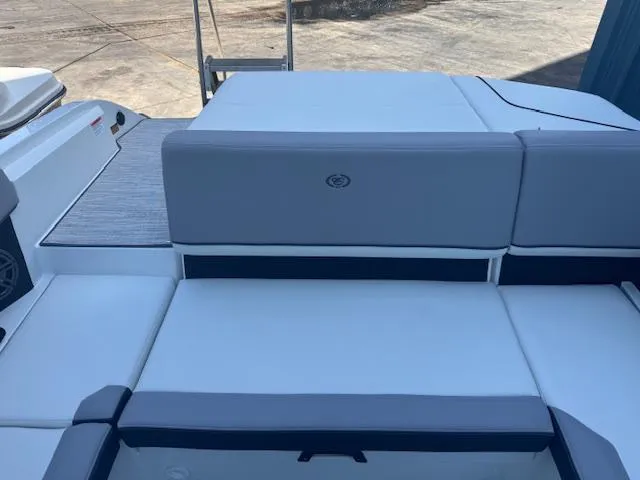 Slide: The Image of 2025 Cobalt CS22 boat interior with gray and white seating, docked on a sunny day. - 24