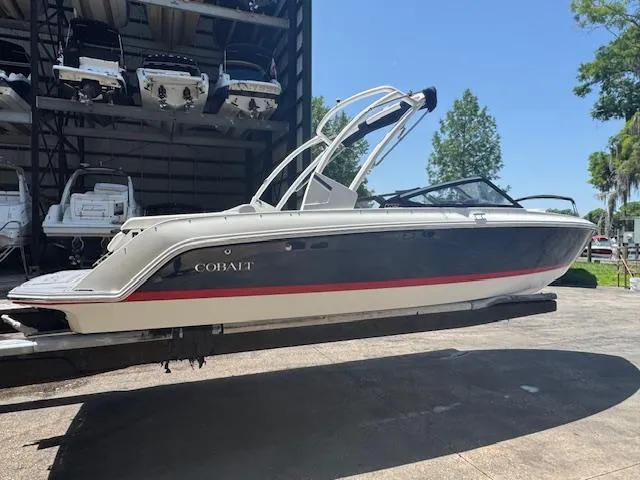 Slide: The Image of 2025 Cobalt CS22 boat on a lift, sleek design, outdoor storage facility. - 3