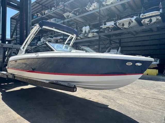 Slide: The Image of 2025 Cobalt CS22 boat in storage facility, sleek design with navy and white exterior. - 4