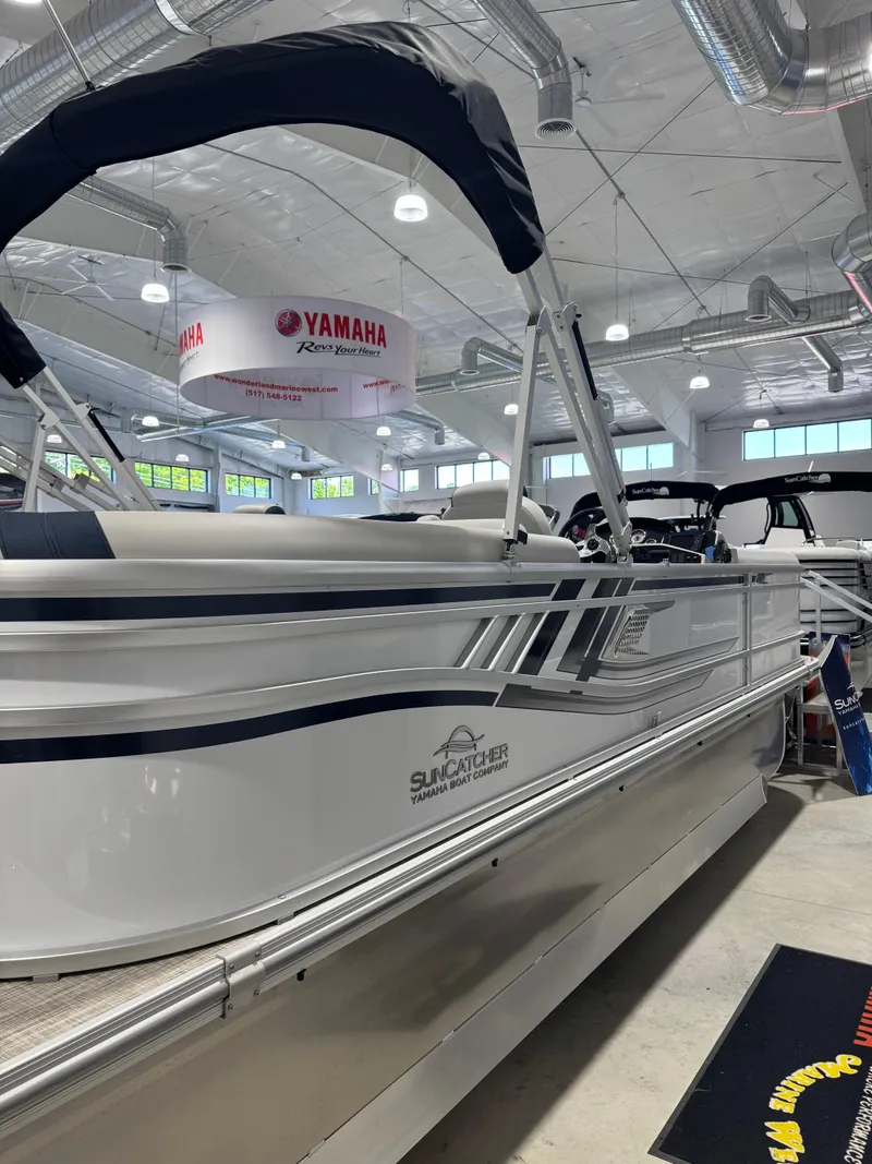 Slide: The Image of 2025 G3 Select 322RC pontoon boat displayed indoors with Yamaha branding. - 0