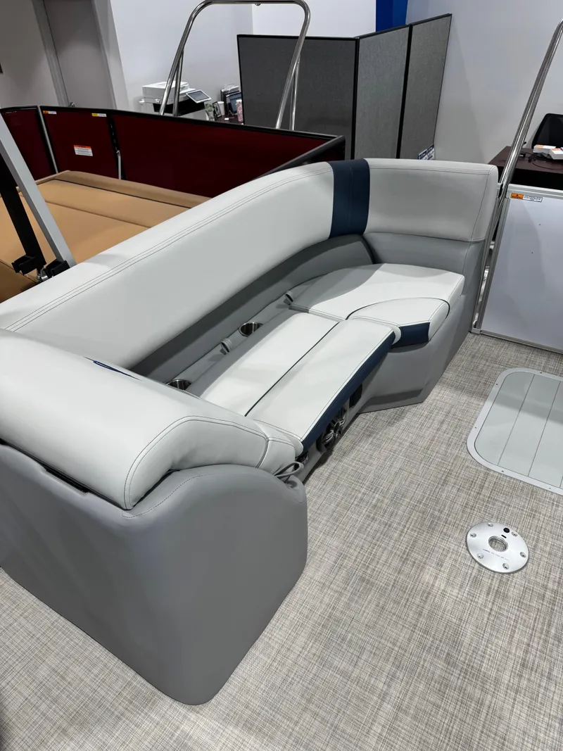 Slide: The Image of 2025 G3 Select 322RC boat interior with gray and blue seating on a carpeted deck. - 12