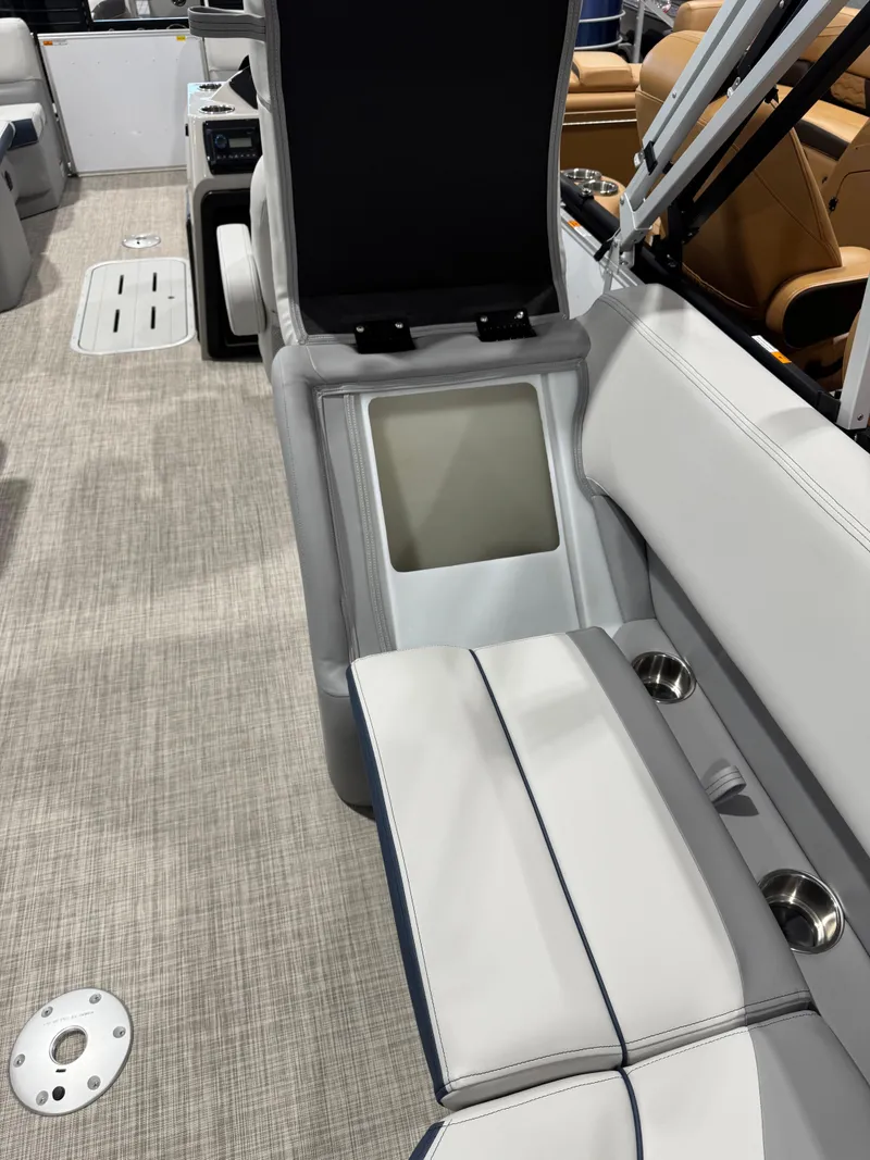 Slide: The Image of 2025 G3 Select 322RC boat interior with cushioned seating and storage compartment. - 14