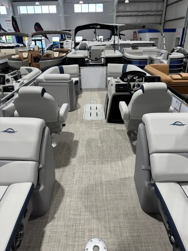 Slide: The Image of 2025 G3 Select 322RC pontoon boat interior with plush seating and modern dashboard. - 15