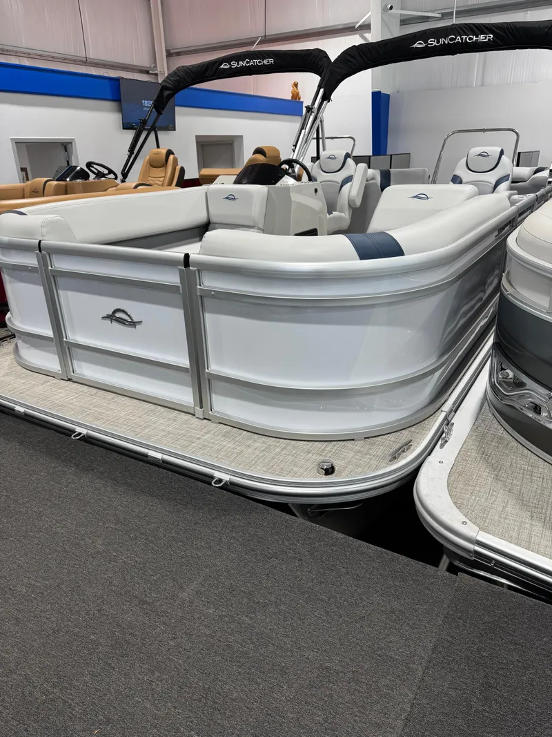 Slide: The Image of 2025 G3 Select 322RC pontoon boat with white seating and sleek design in showroom. - 2