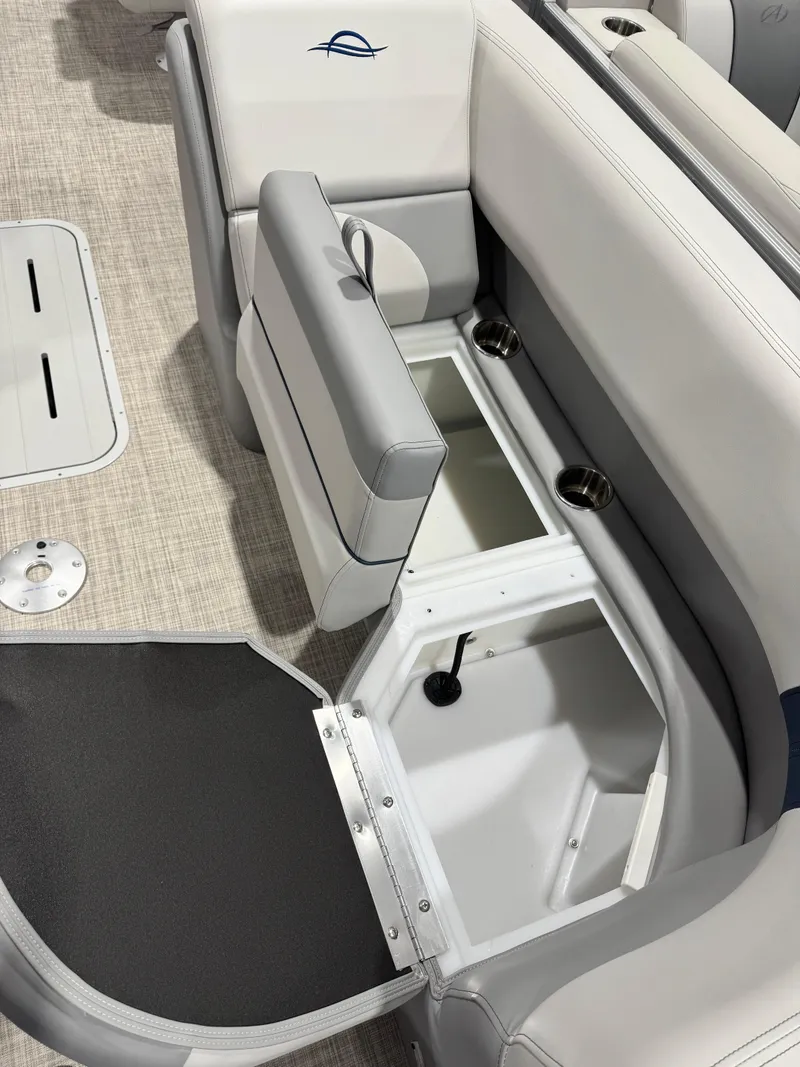 Slide: The Image of 2025 G3 Select 322RC boat interior with open storage compartments and cup holders. - 6