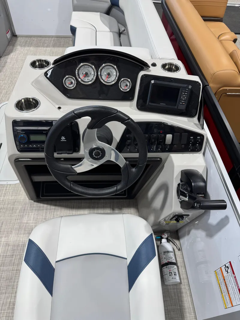 Slide: The Image of 2025 G3 Select 322RC boat dashboard with steering wheel, gauges, and controls. - 8
