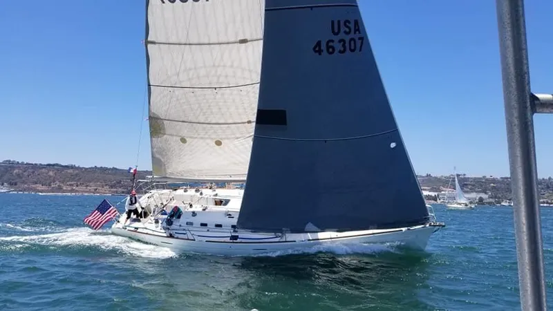 Slide: The Image of Sailing yacht Beneteau First 47.7 (2001) with USA flag on open water. - 0