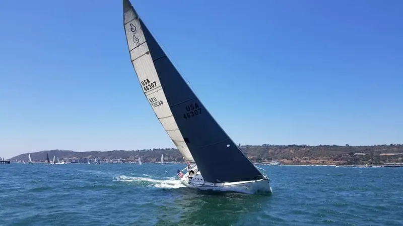 Slide: The Image of Sailing yacht Beneteau First 47.7, 2001 model, gliding on open water under clear skies. - 19