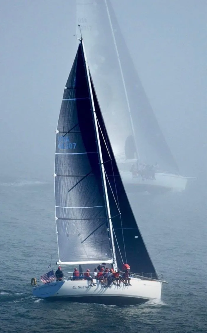 Slide: The Image of Sailboat Beneteau First 47.7, 2001 model, navigating through foggy waters. - 5
