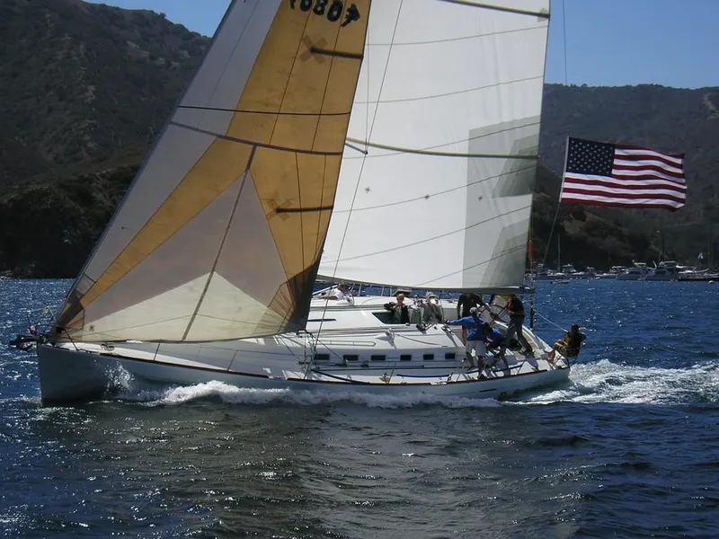 Slide: The Image of Sailing yacht Beneteau First 47.7 (2001) with American flag on open water. - 7