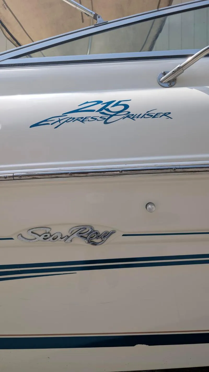 Slide: The Image of 1997 Sea Ray 215 Express Cruiser boat side view with logo and model name. - 13