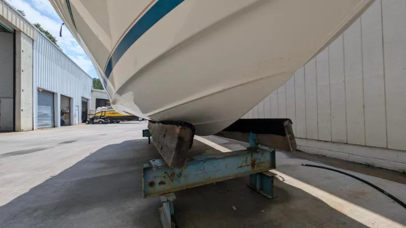 Slide: The Image of 1997 Sea Ray 215 Express Cruiser on a trailer in a boatyard. - 4