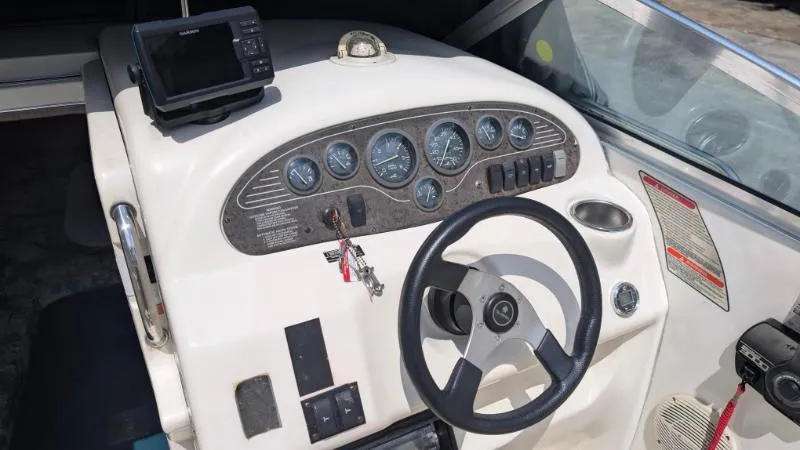 Slide: The Image of 1997 Sea Ray 215 Express Cruiser dashboard with steering wheel and instrument panel. - 5