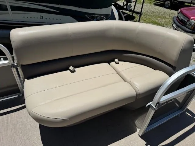 Slide: The Image of 2024 Sun Tracker Party Barge 16 DLX beige seating area on a pontoon boat. - 44