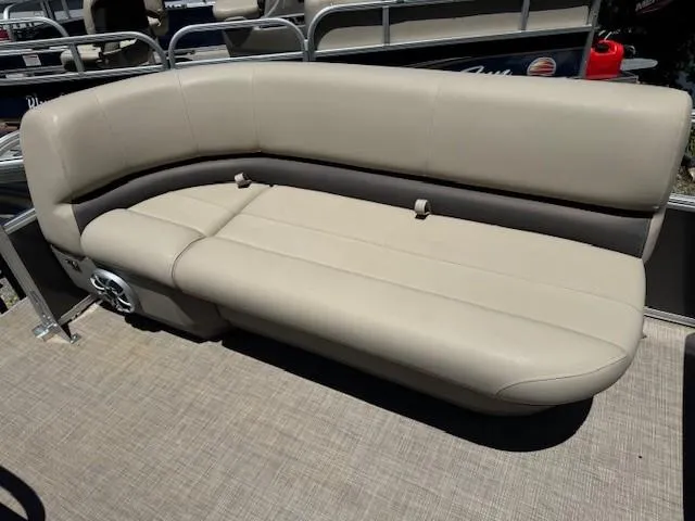 Slide: The Image of 2024 Sun Tracker Party Barge 16 DLX beige seating on pontoon boat deck. - 45