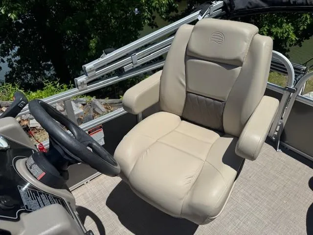 Slide: The Image of 2024 Sun Tracker Party Barge 16 DLX captain's chair, beige leather, near steering wheel. - 48