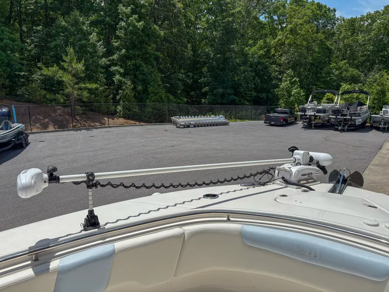 Slide: The Image of 2023 Robalo R302 boat with trolling motor in a parking lot. - 13