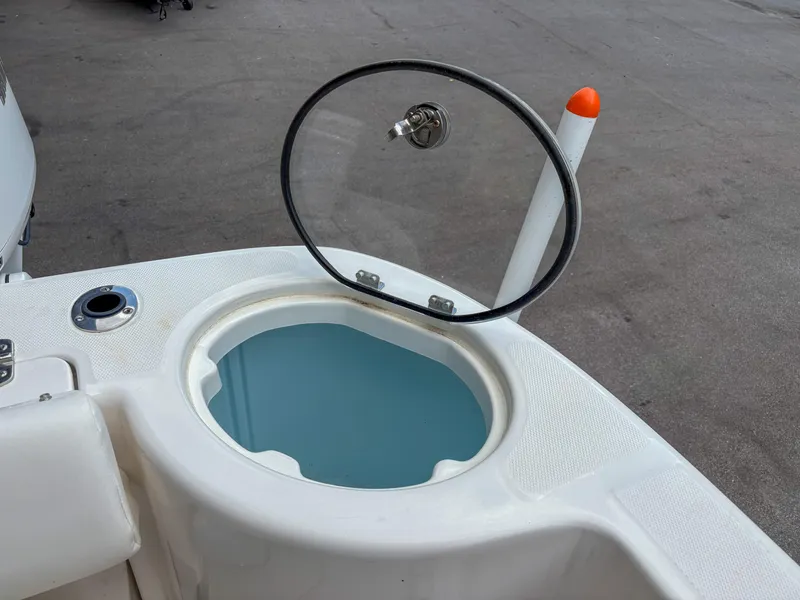 Slide: The Image of 2023 Robalo R302 boat livewell with open lid, showcasing interior design. - 14