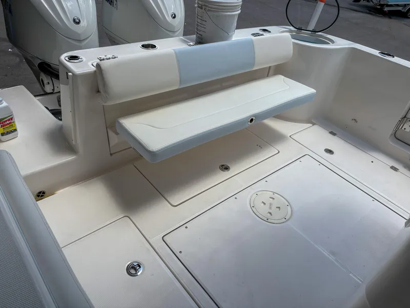 Slide: The Image of 2023 Robalo R302 boat interior with foldable seating and storage compartments. - 6