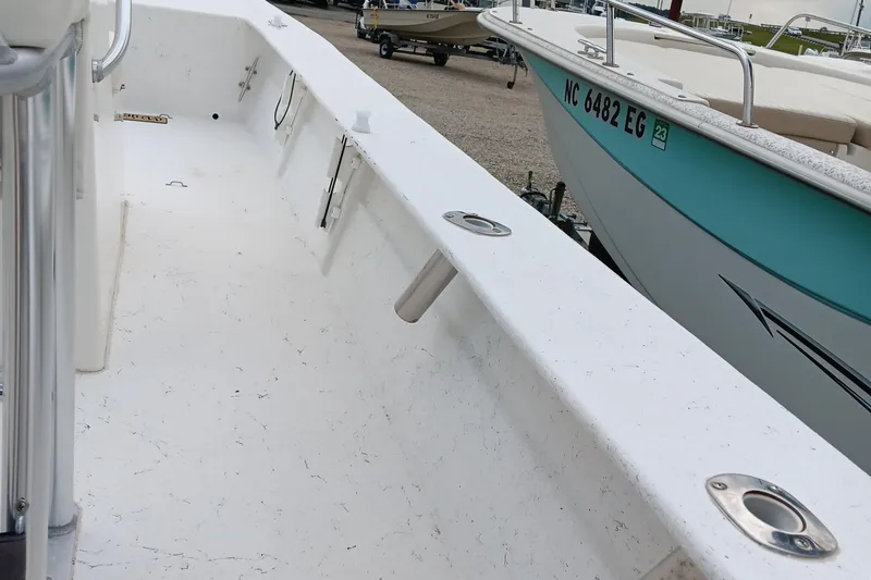 Slide: The Image of 2020 May-Craft 19 Cape Classic boat interior, white deck, rod holders, adjacent boat visible. - 13