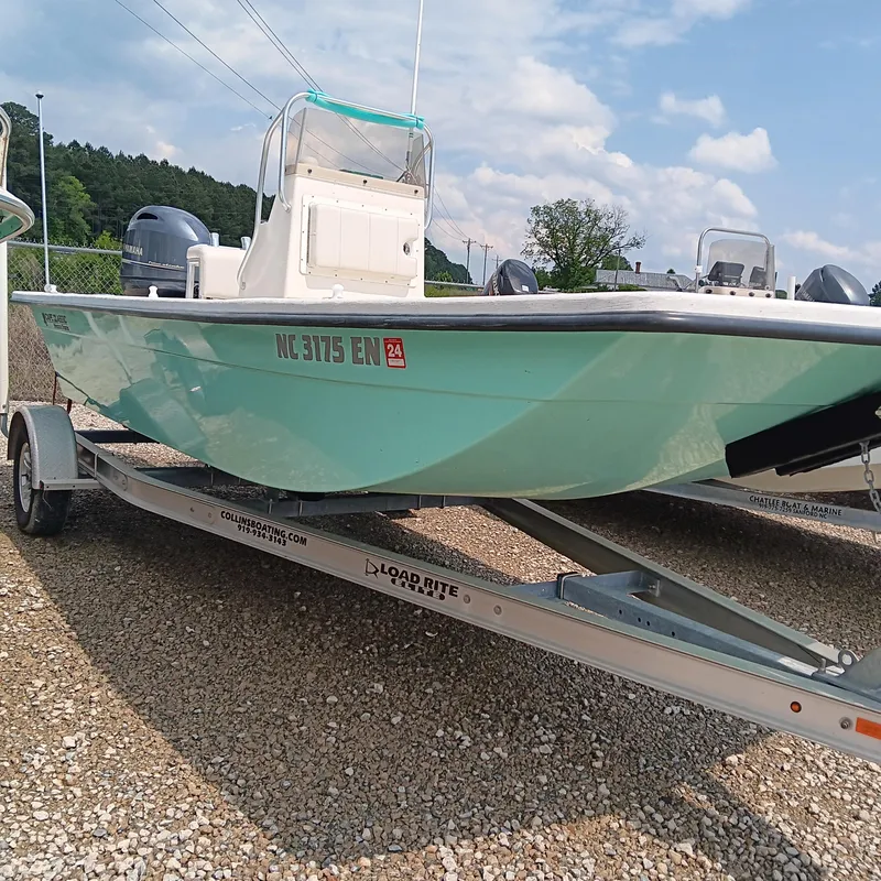 Slide: The Image of 2020 May-Craft 19 Cape Classic boat on trailer, light blue hull, parked on gravel. - 2