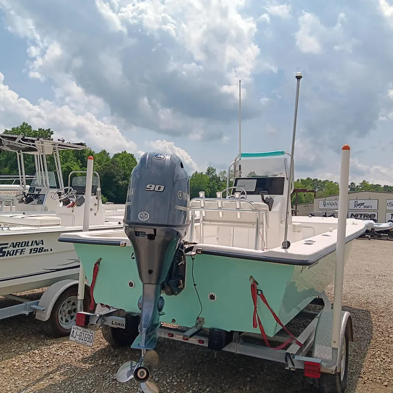Slide: The Image of 2020 May-Craft 19 Cape Classic boat on trailer, with outboard motor, under cloudy sky. - 5