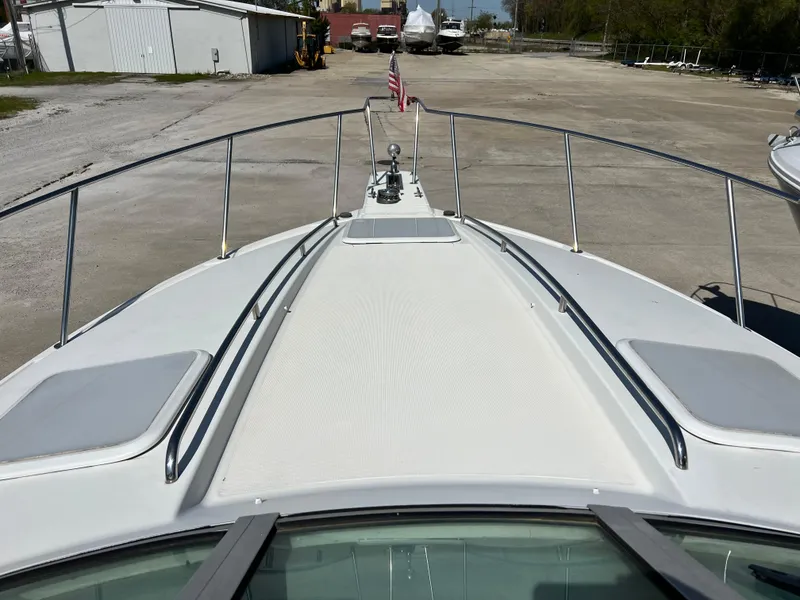 Slide: The Image of 1999 Formula 31 PC boat deck view with railings and American flag. - 10
