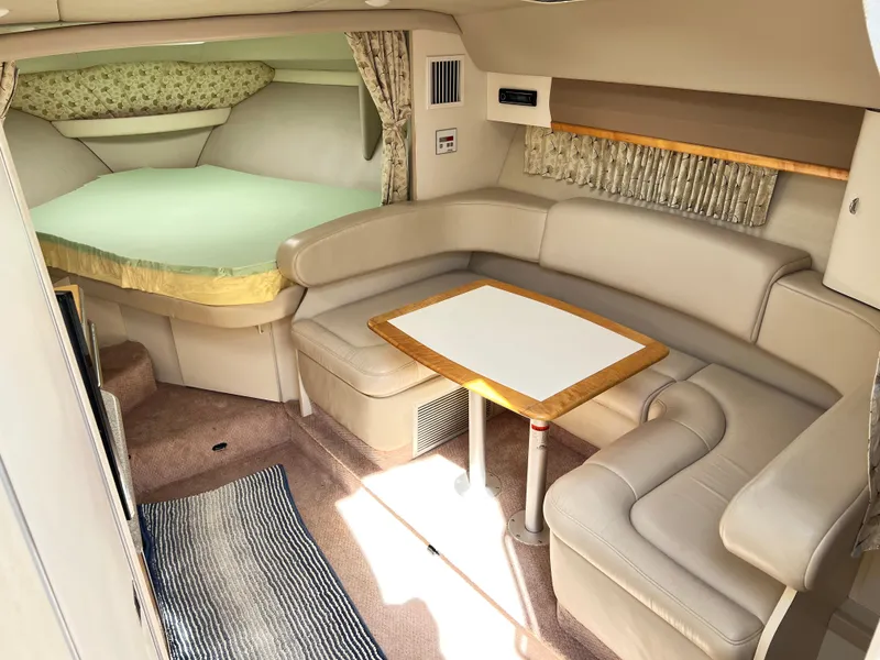Slide: The Image of 1999 Formula 31 PC cabin interior with seating, table, and bed. - 12