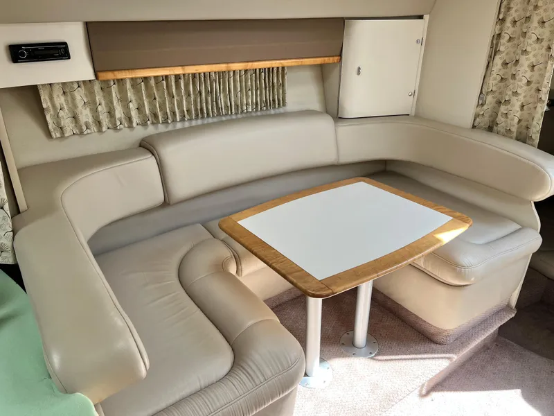 Slide: The Image of 1999 Formula 31 PC interior with beige leather seating and wooden table. - 13