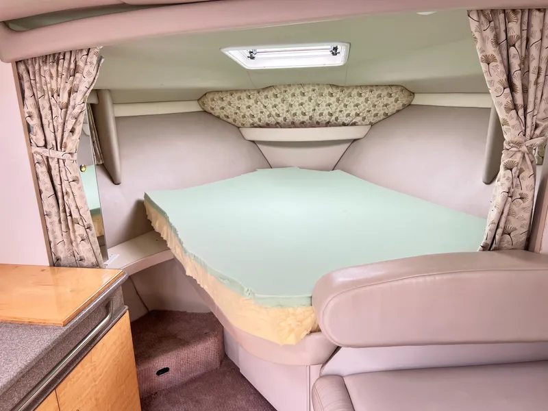 Slide: The Image of 1999 Formula 31 PC cabin interior with bed, curtains, and skylight. - 15