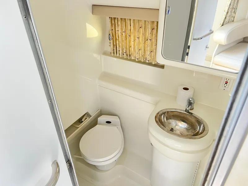 Slide: The Image of 1999 Formula 31 PC boat bathroom with toilet, sink, and mirror. - 17