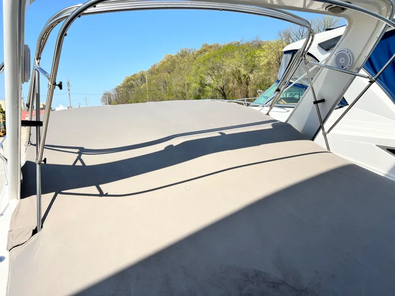 Slide: The Image of 1999 Formula 31 PC boat deck with canopy, under clear blue sky. - 19