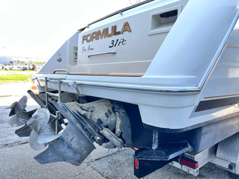 Slide: The Image of 1999 Formula 31 PC boat stern view with propellers and branding. - 4