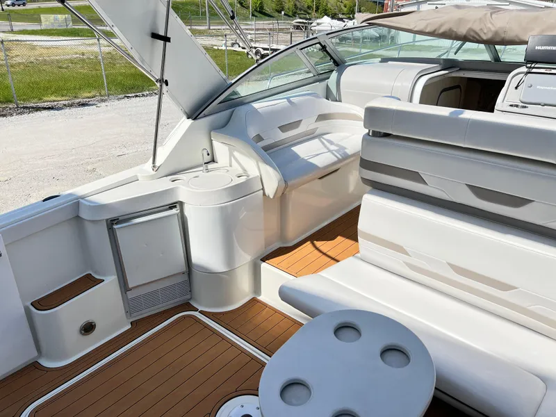 Slide: The Image of 1999 Formula 31 PC boat interior with seating and table, featuring sleek design and wood flooring. - 7