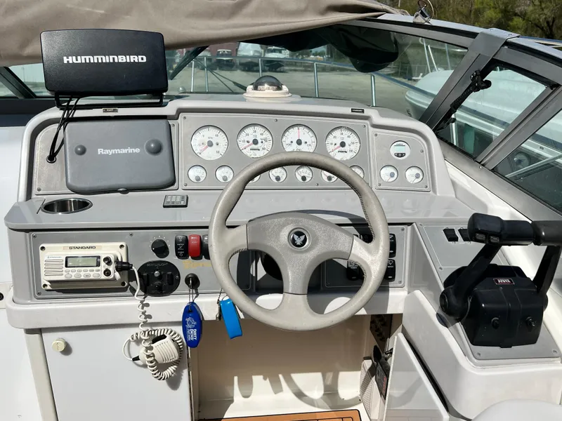 Slide: The Image of 1999 Formula 31 PC boat dashboard with steering wheel, gauges, and navigation equipment. - 9