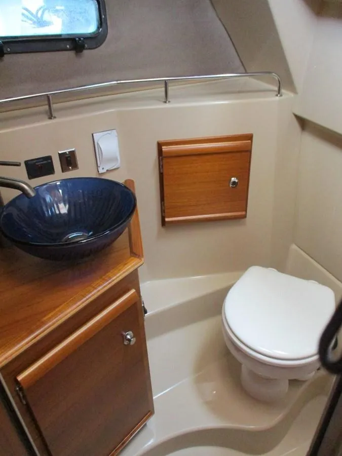 Slide: The Image of 2020 Ranger Tugs R-27 LE bathroom with modern sink and compact toilet. - 16