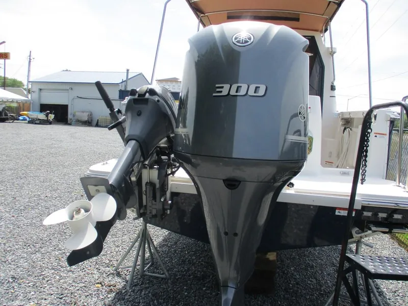 Slide: The Image of 2020 Ranger Tugs R-27 LE with Yamaha 300 outboard motor, displayed on gravel surface. - 3