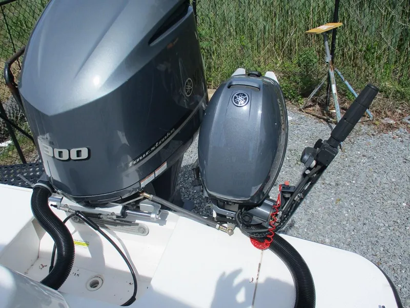 Slide: The Image of Yamaha outboard motors on a 2020 Ranger Tugs R-27 LE boat, parked on gravel. - 7