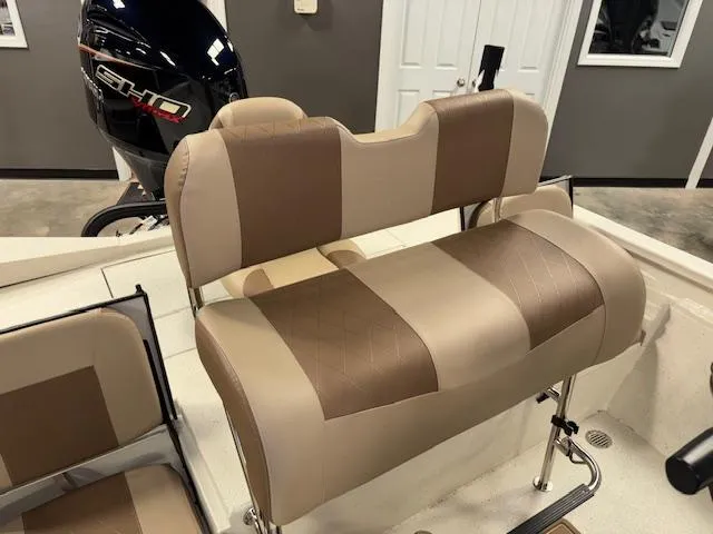 Slide: The Image of 2025 Xpress H22 Bay boat with beige and brown seating, featuring a powerful outboard motor. - 10