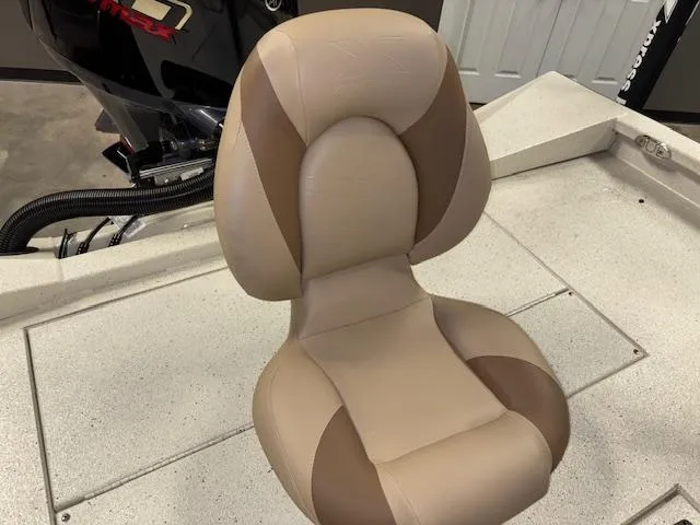 Slide: The Image of 2025 Xpress H22 Bay boat seat, beige and brown, on deck near motor. - 11