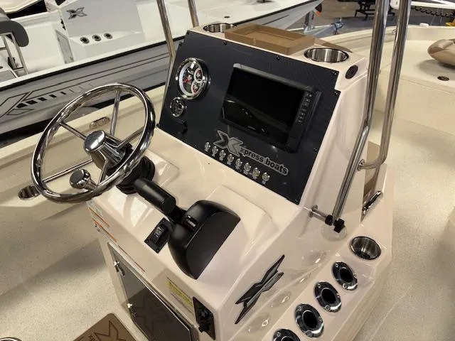 Slide: The Image of 2025 Xpress H22 Bay boat console with steering wheel and control panel. - 12