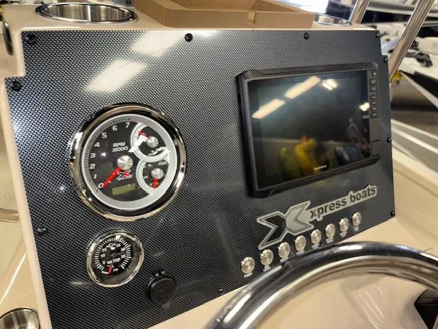 Slide: The Image of Dashboard of 2025 Xpress H22 Bay boat with gauges and touchscreen display. - 14