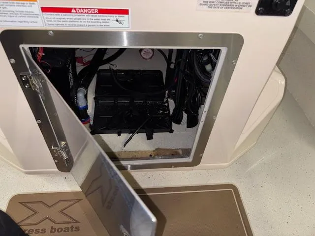 Slide: The Image of 2025 Xpress H22 Bay boat battery compartment with open access panel. - 16